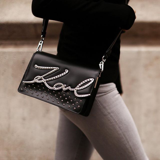 Head into the holidays with a rock-chic bag. This signature style is this topped with shiny silver studs. #KARLLAGERFELD
