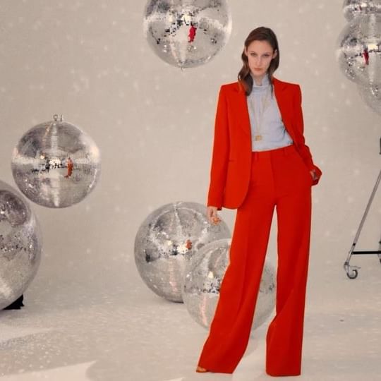 The red #VBPreSS19 suit, as worn by @oliviapalermo last week at the #FashionAwards, paired here with the bottle necklace and sheer top! Shop online or at #VBDoverSt x VB #KissesAtChristmas