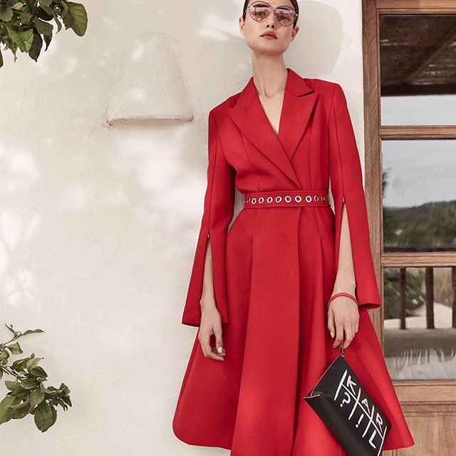 Embrace the glamour of a crimson capelet coat-dress. #KARLLAGERFELD