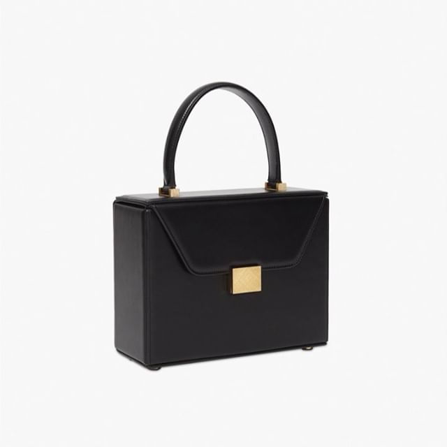 The perfect little black evening bag. The Vanity Top Handle bag is inspired by a vanity case with a sleek mirror embossed with the VB logo. Love this accessory! Discover it at the link in bio x VB